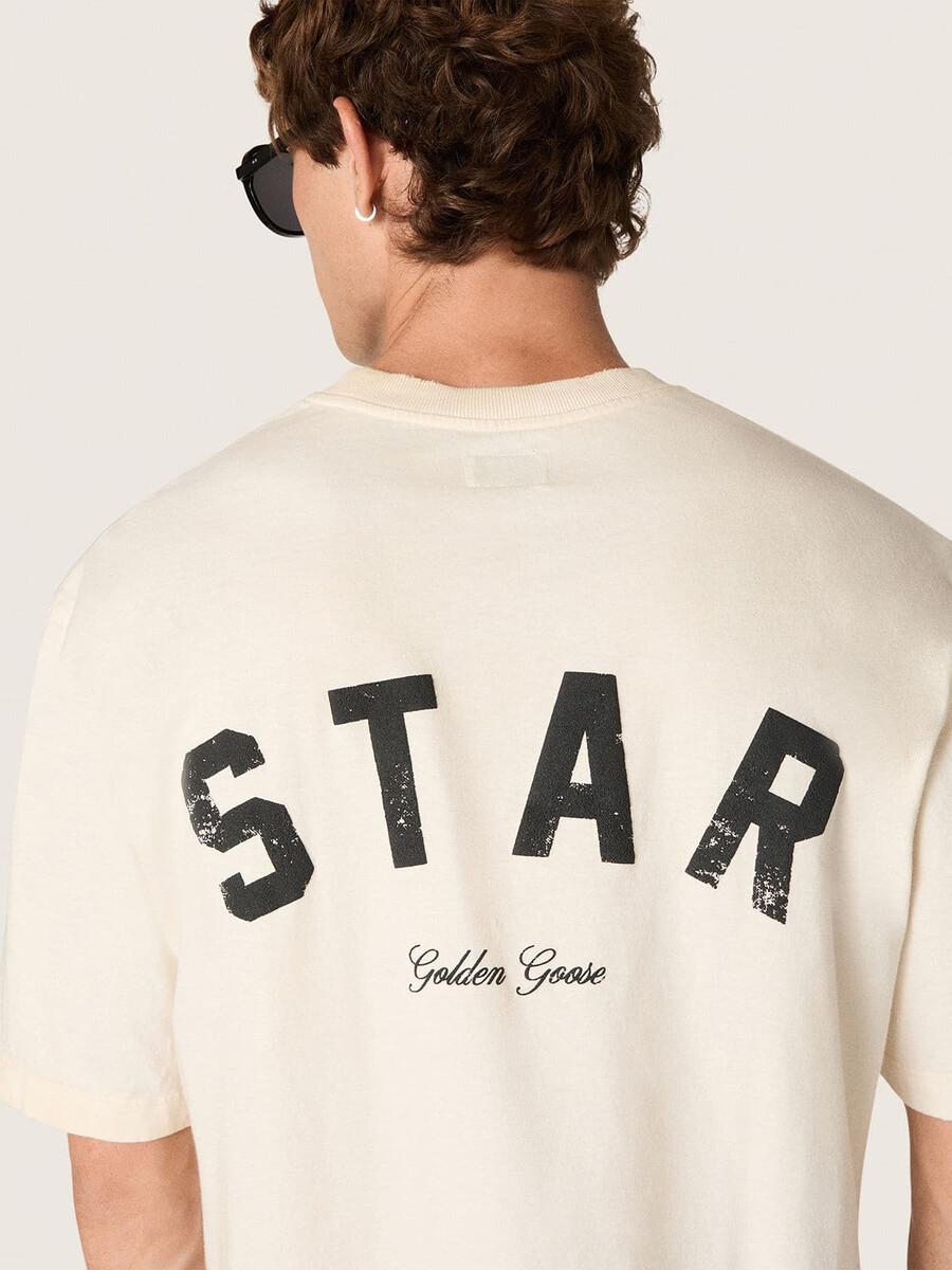 unisex katoenen t-shirt met sterrenprint in vintage wit met zwarte opdruk op de achterkant.