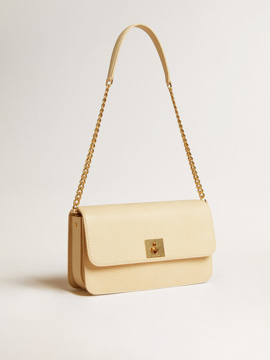 gioia-tas van vanillekleurig schapenleer met gouden details.