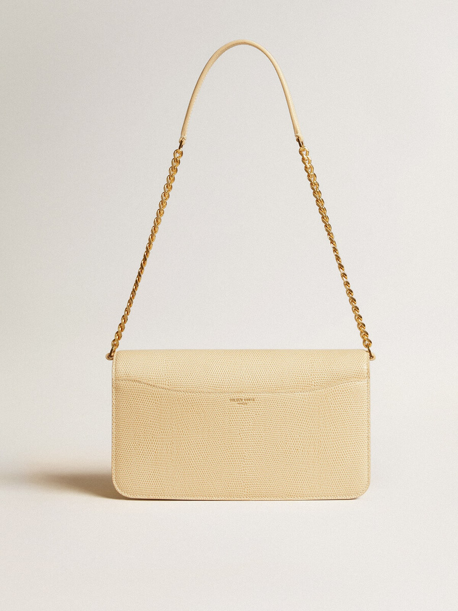 gioia-tas van vanillekleurig schapenleer met gouden details.