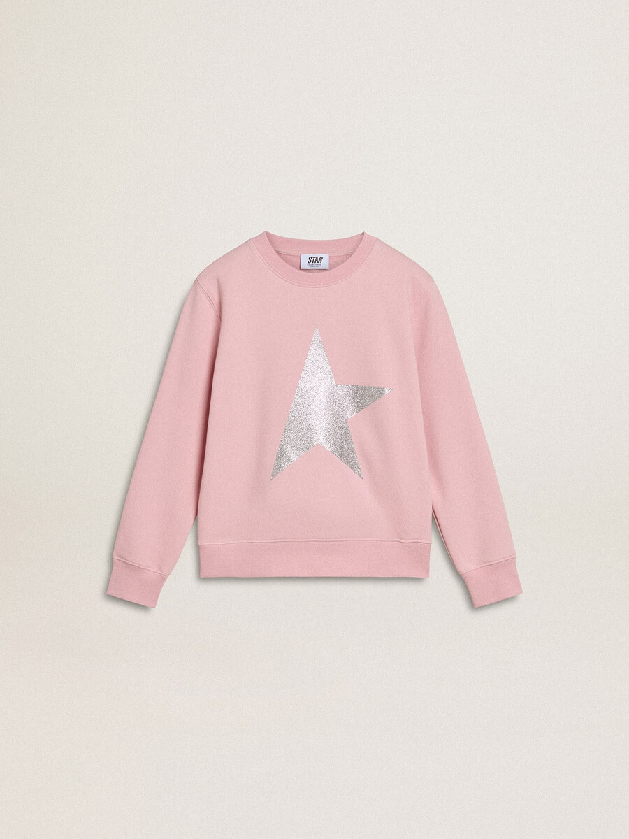 roze sweatshirt met een grote ster van zilveren glitter op de voorkant.