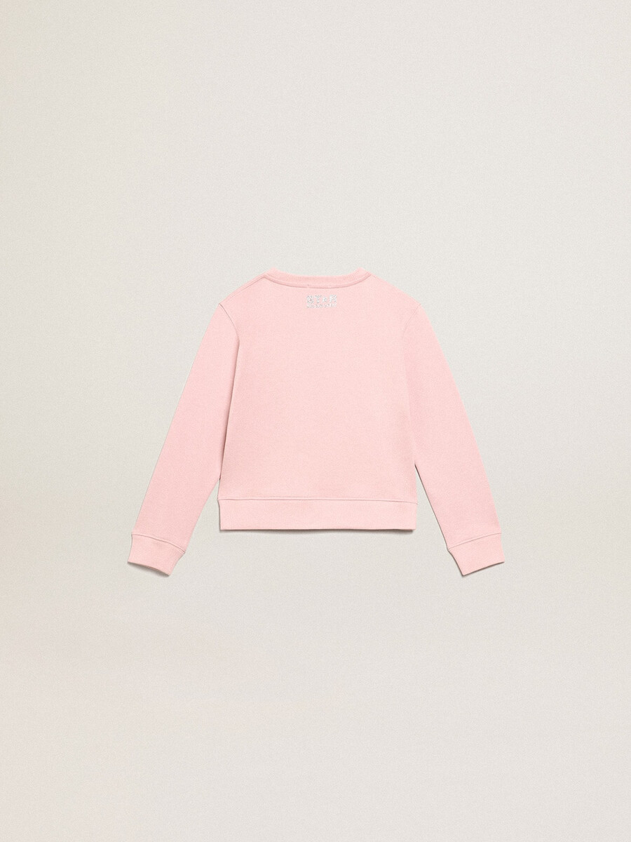 roze sweatshirt met een grote ster van zilveren glitter op de voorkant.