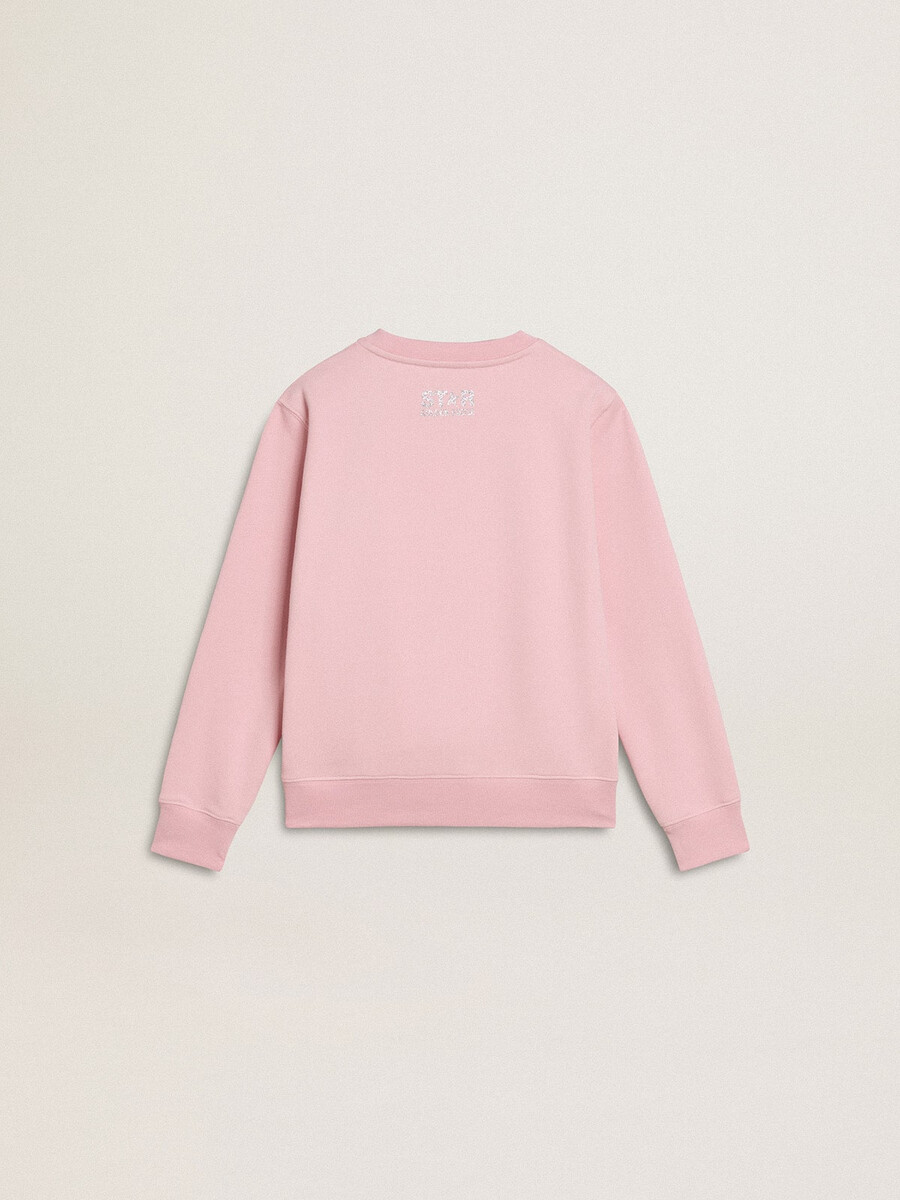 roze sweatshirt met een grote ster van zilveren glitter op de voorkant.