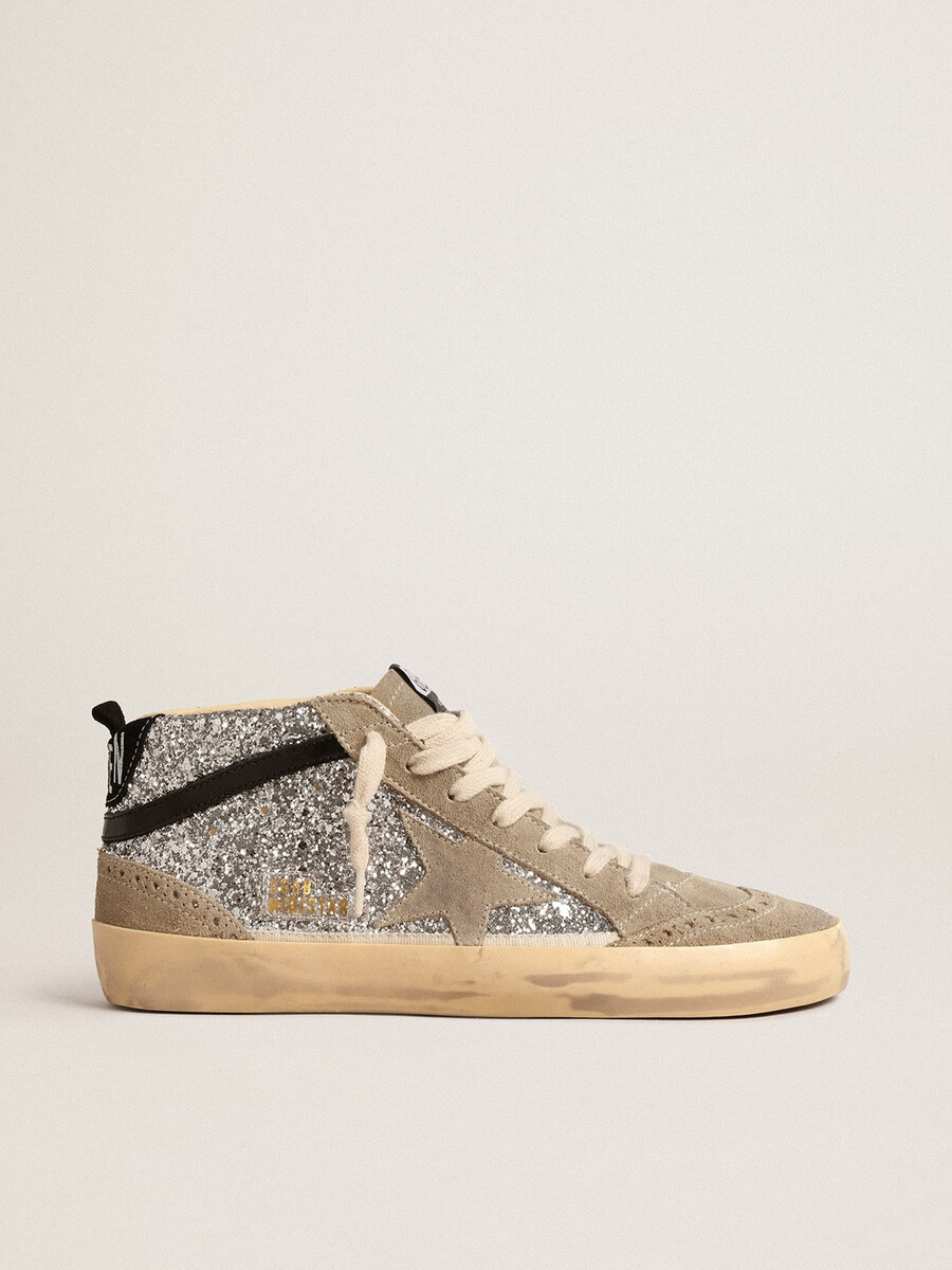 mid star in zilverkleurige glitter met suède ster en zwarte accenten.