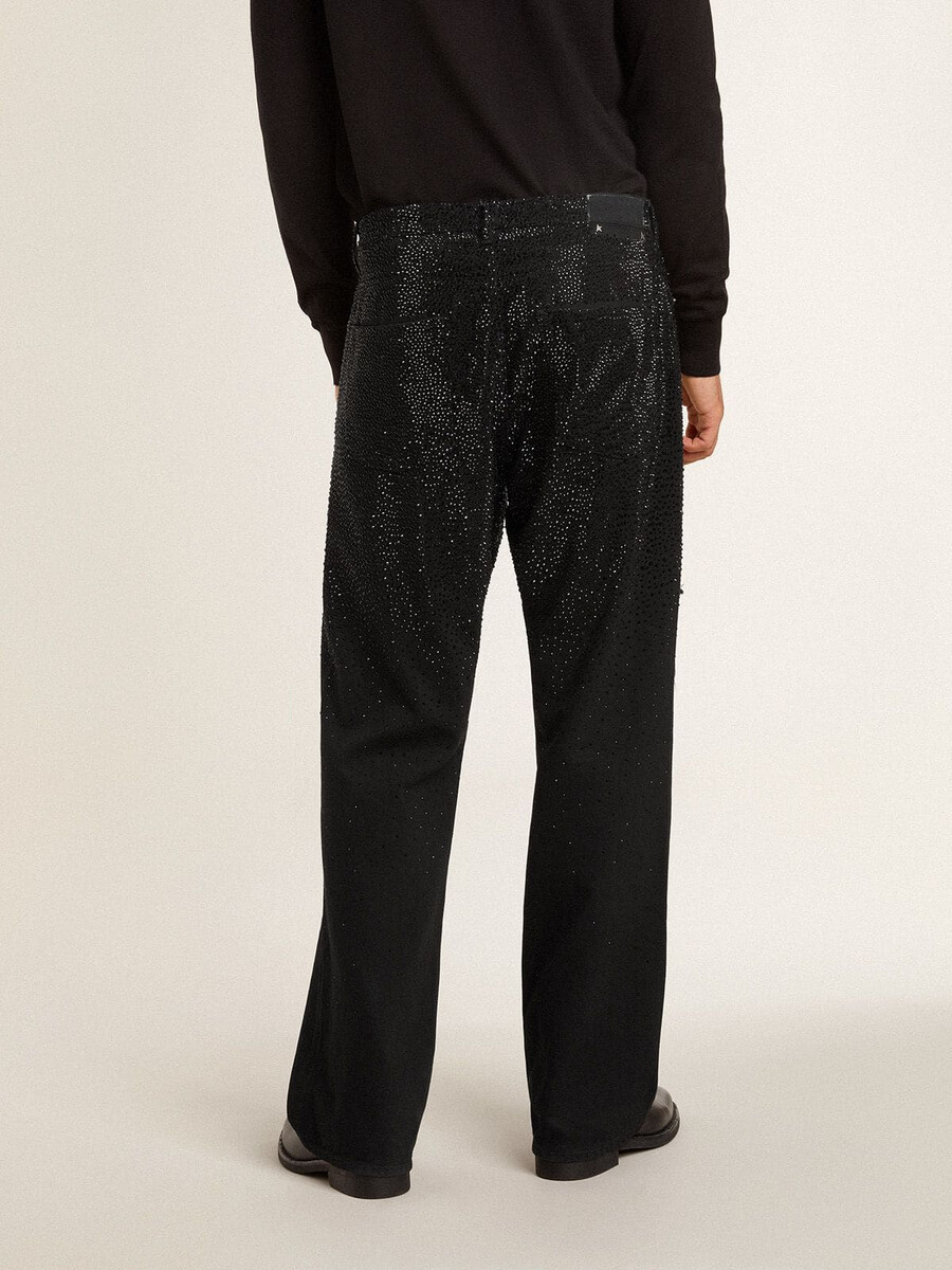 zwarte herenjeans met een losse pasvorm en een kristallen afwerking met kleurverloop.
