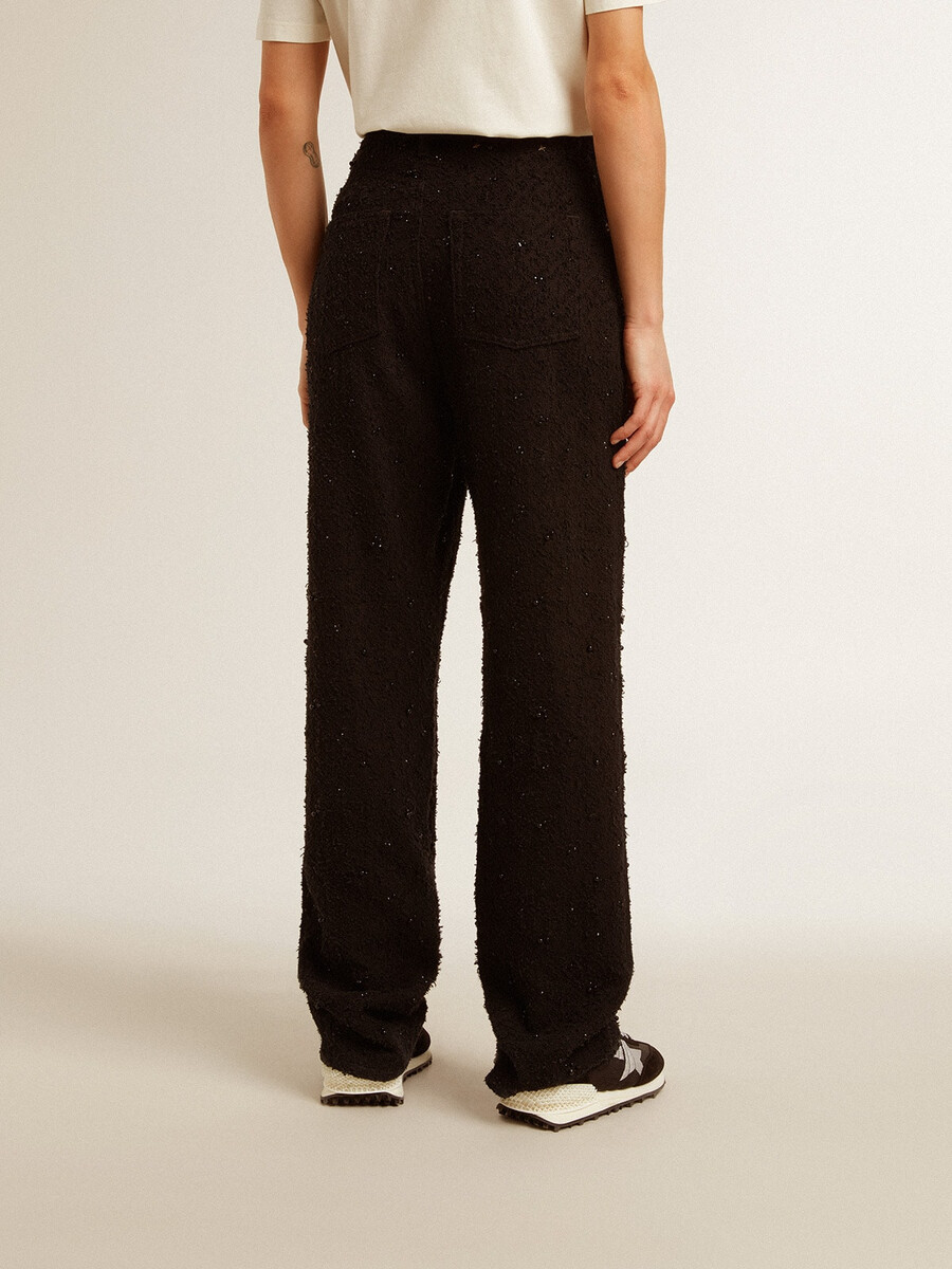 damesbroek van katoenen denim met versiering van kristallen en stenen.
