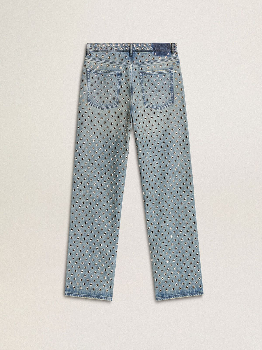 damesjeans met een verwassen look en overal perforaties.