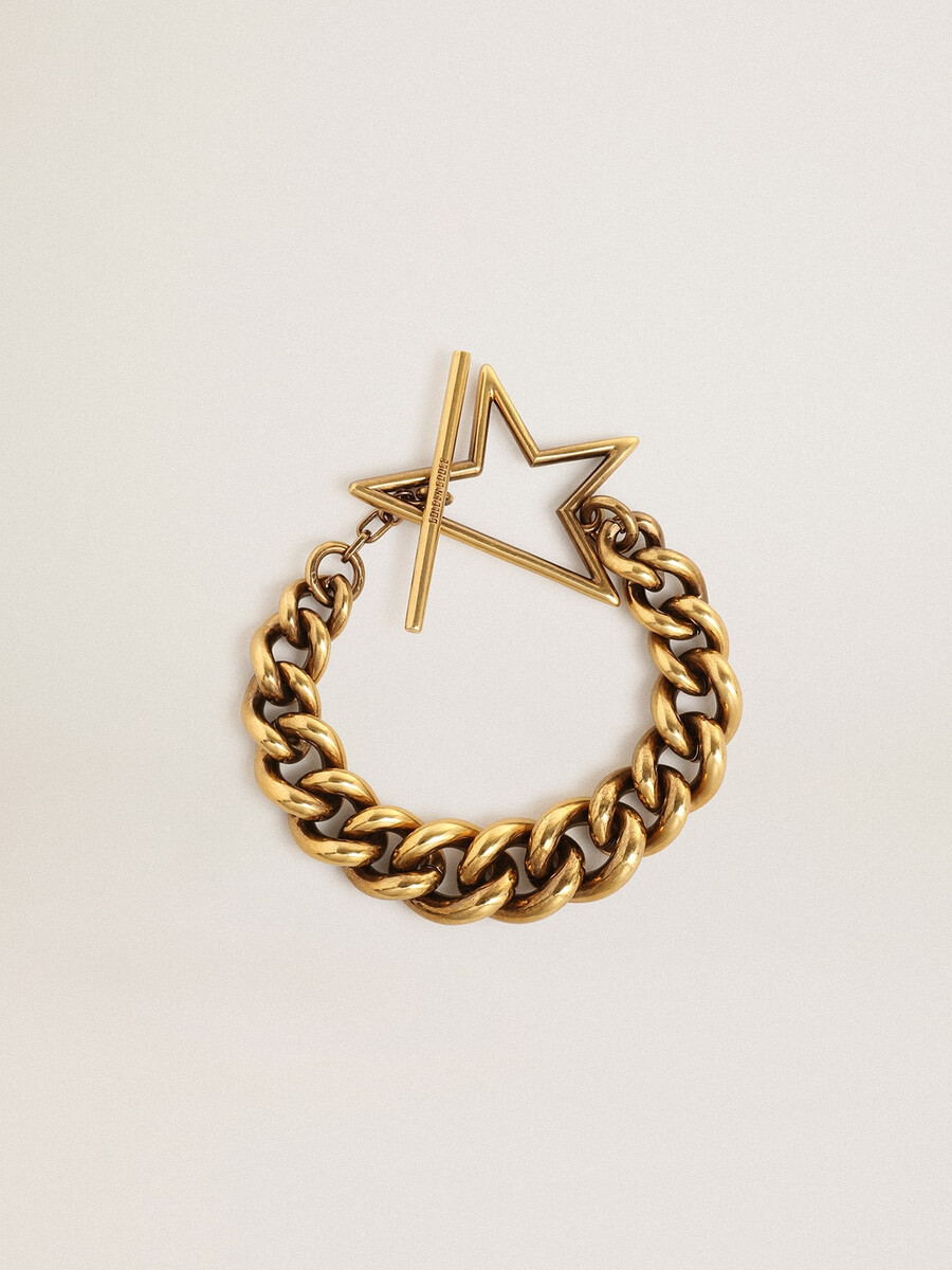 armband van antiek goud met een aflopende schakelketting en een stervormige sluiting.