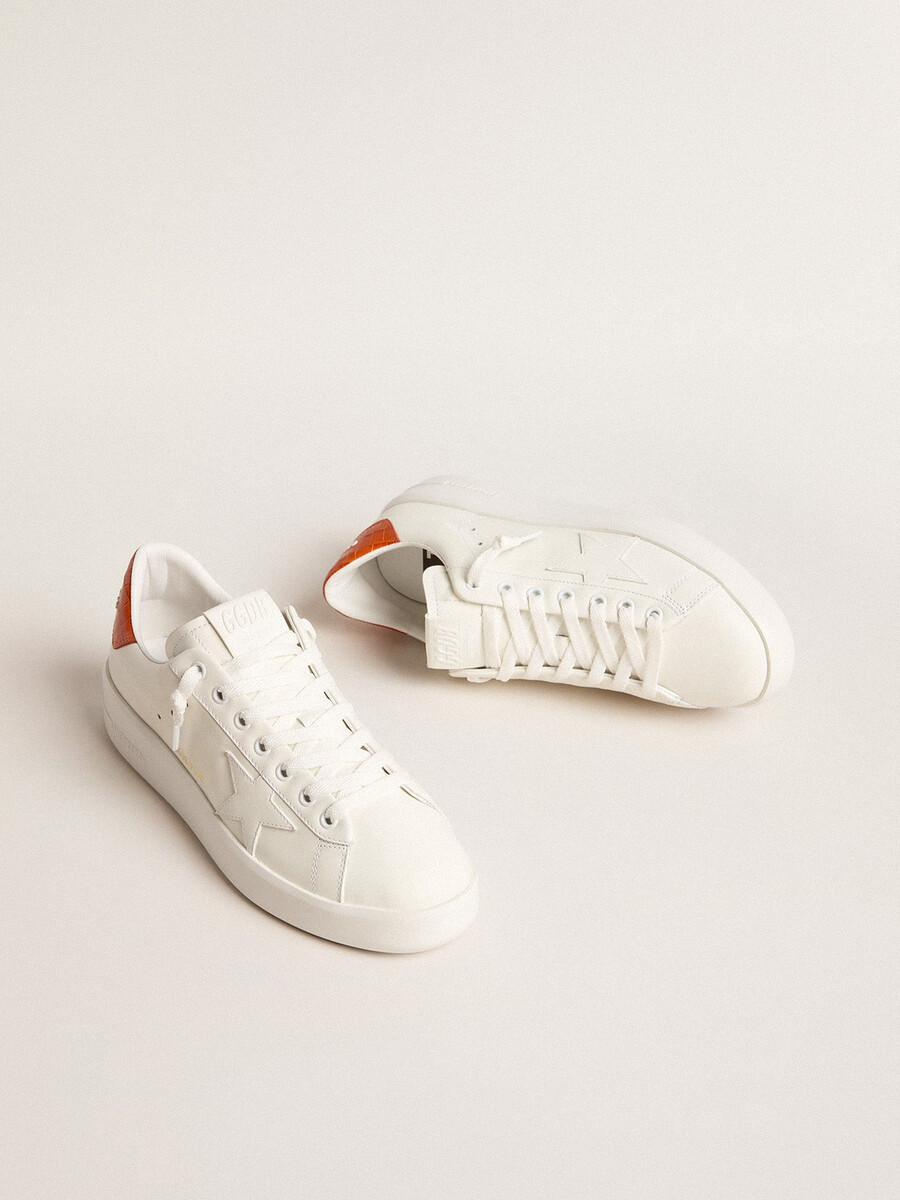 dames purestar met witte leren ster en oranje hielstuk.