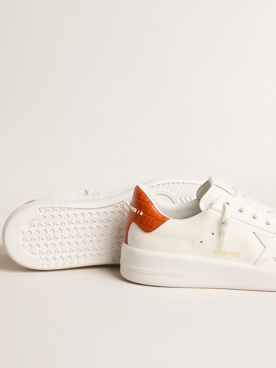dames purestar met witte leren ster en oranje hielstuk.
