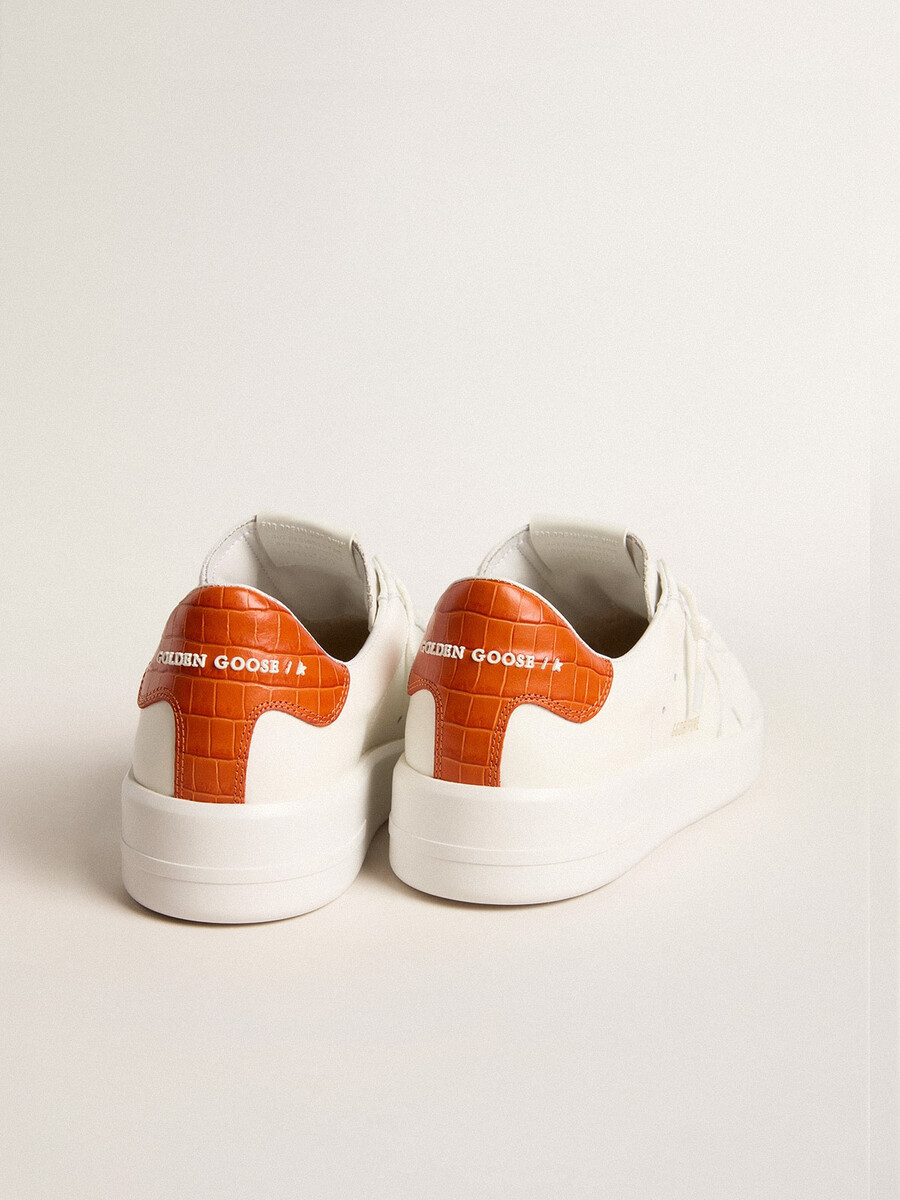 dames purestar met witte leren ster en oranje hielstuk.