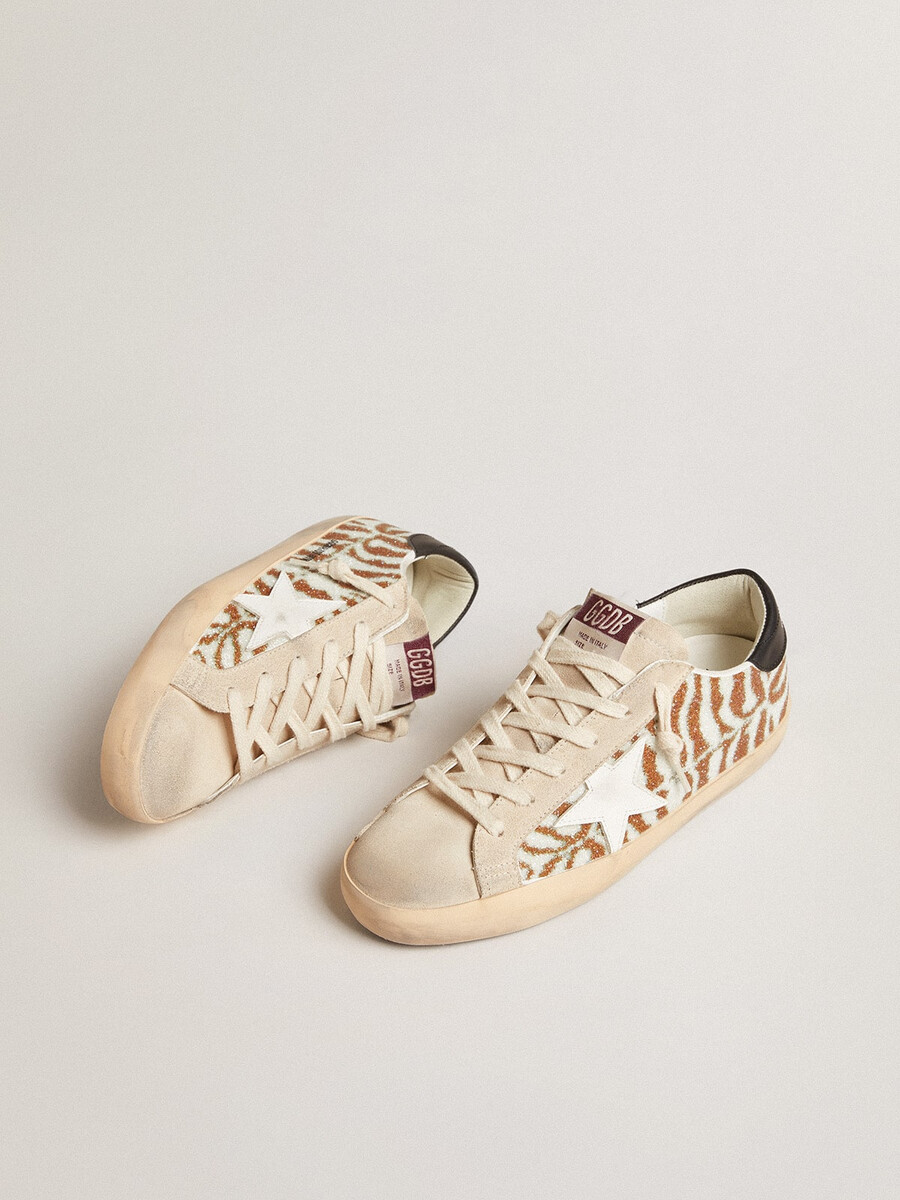 superster in zebraprint van swarovski met een witte leren ster.