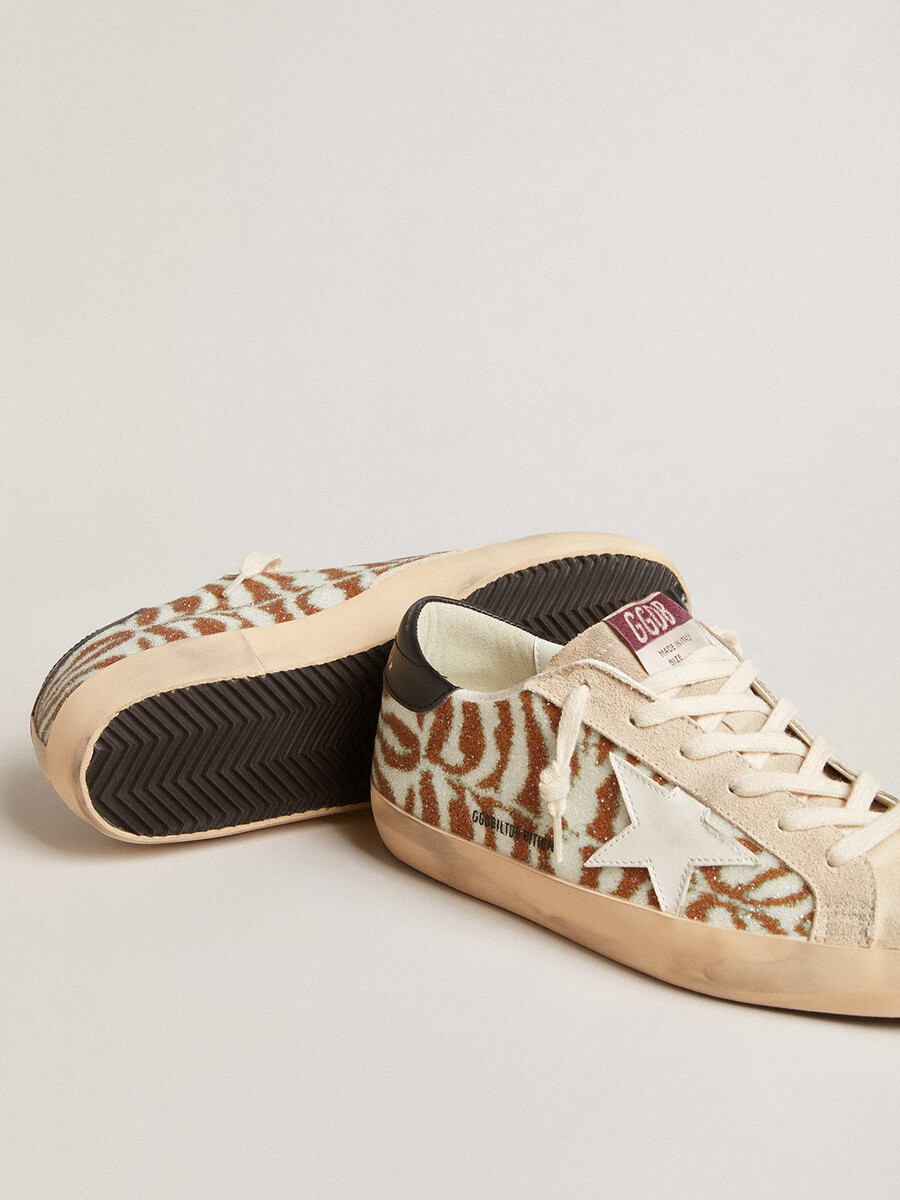 superster in zebraprint van swarovski met een witte leren ster.