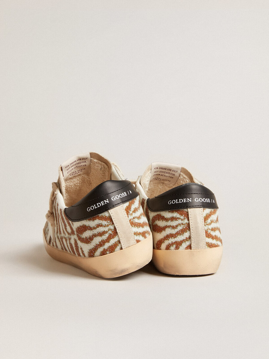 superster in zebraprint van swarovski met een witte leren ster.
