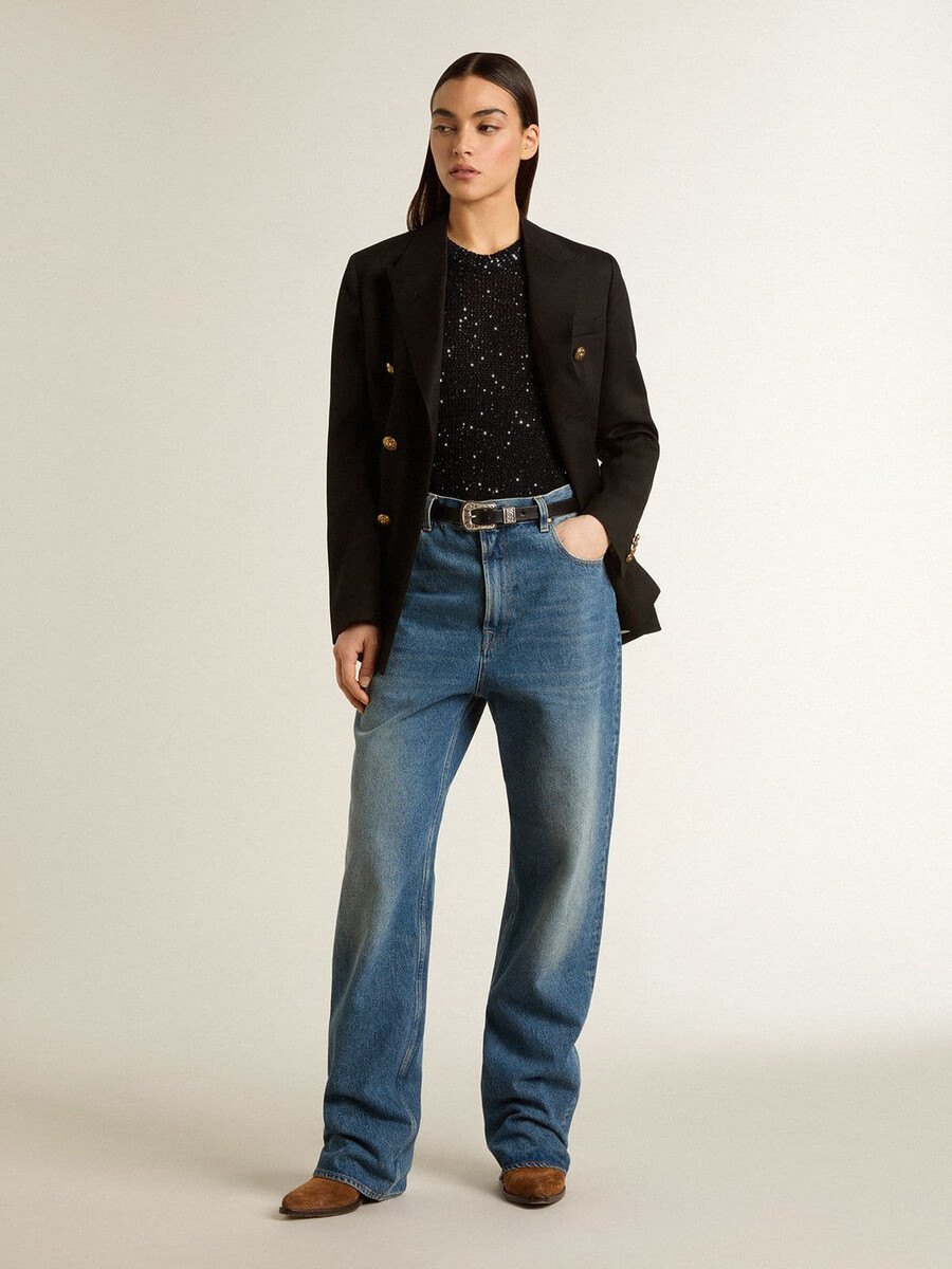 zwarte top van mesh-stof met pailletten en contrasterende details.