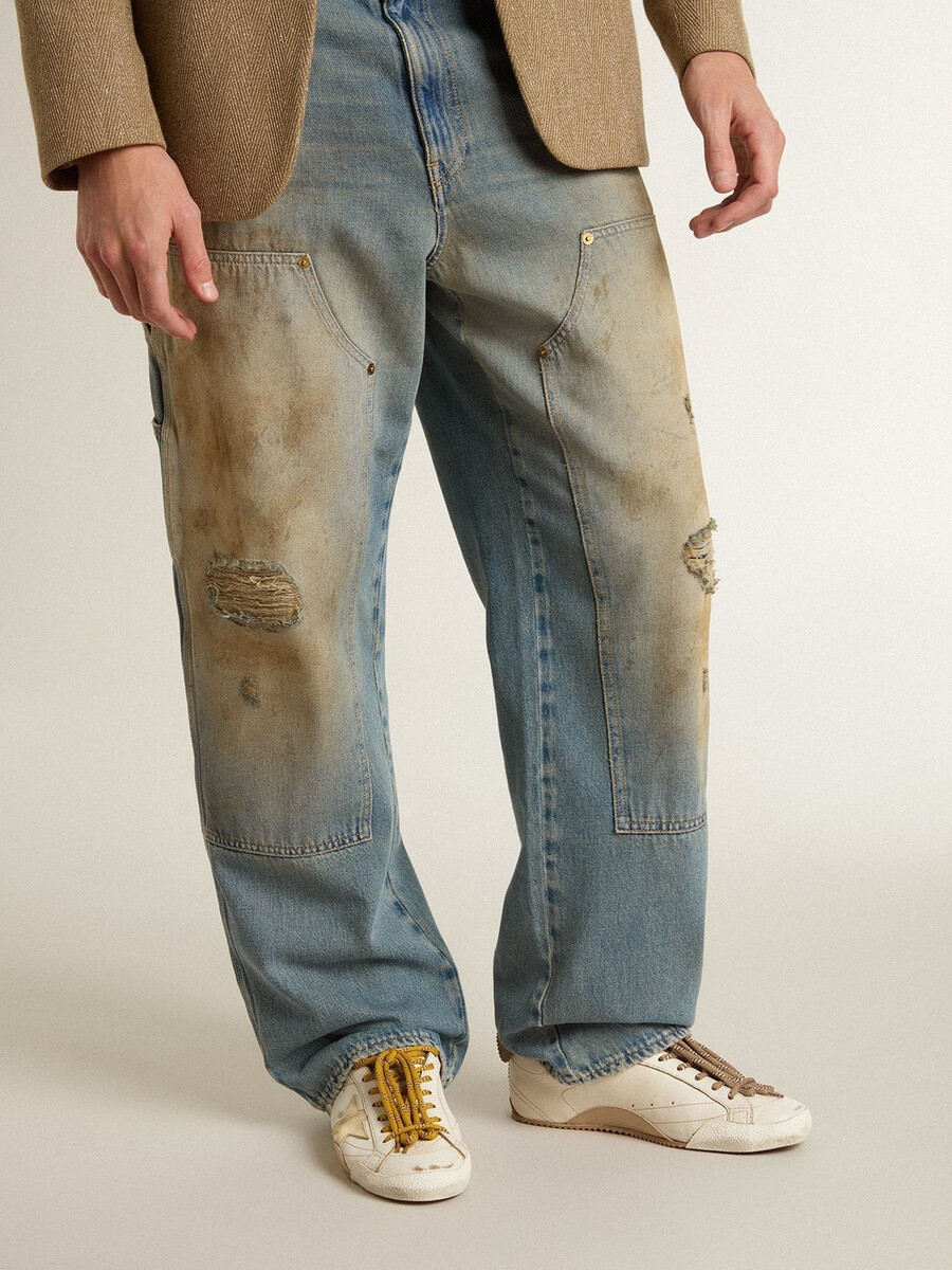 true-star herenschoen in wit nappaleer met een goudkleurige leren ster en een hielstuk van beige suède.