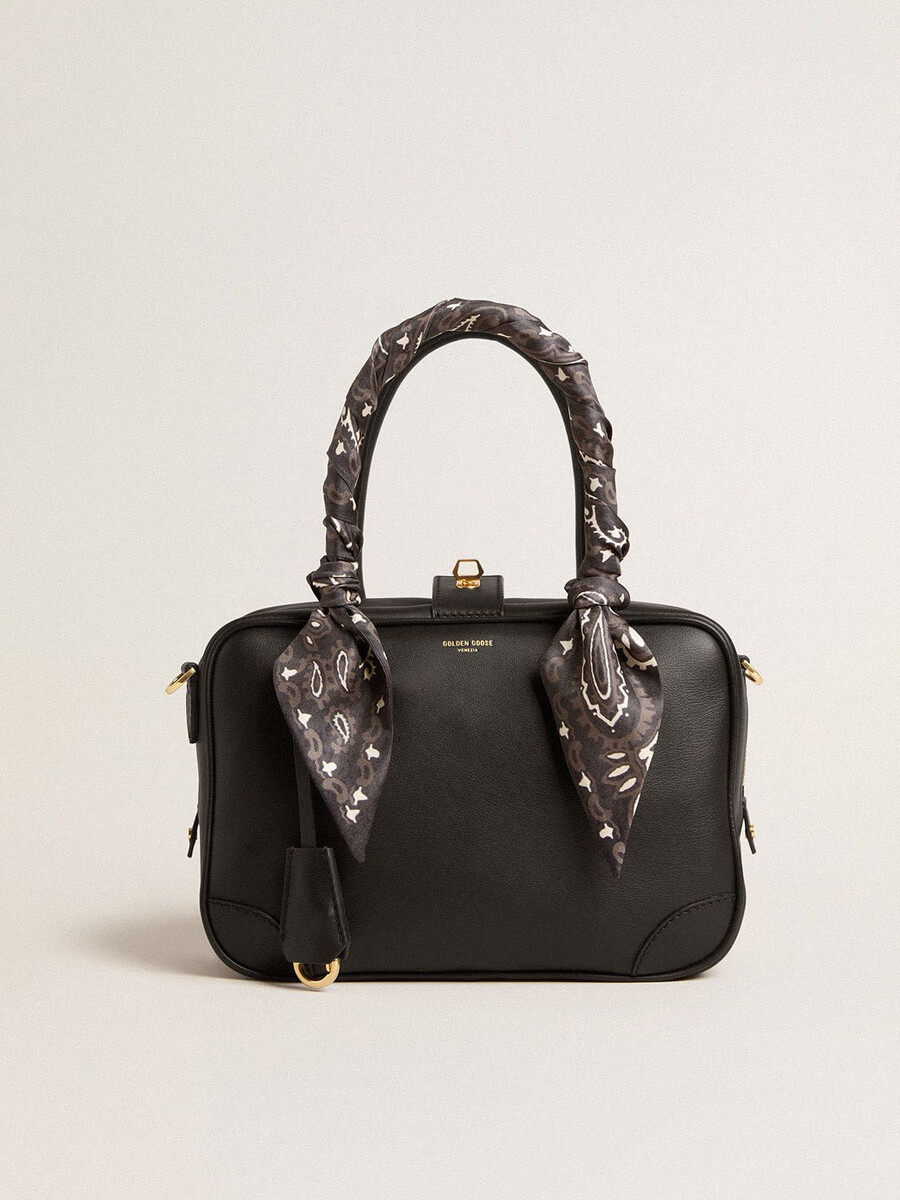 vita-tas van glad zwart leer met gouden details.